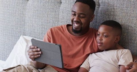 Father and Son Enjoying Time Together Using Tablet