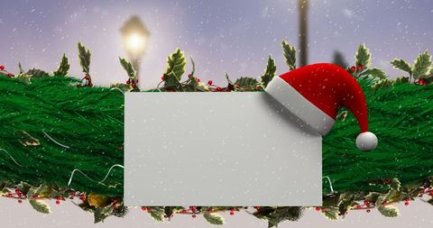 Christmas Card with Santa Hat on Evergreen Garland Background