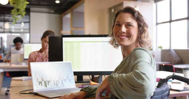 Smiling Businesswoman with Laptop in Modern Office Setting - Download Free Stock Images Pikwizard.com