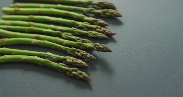Image of fresh asparagus with copy space over grey background. fusion food, fresh vegetables and healthy eating concept.
