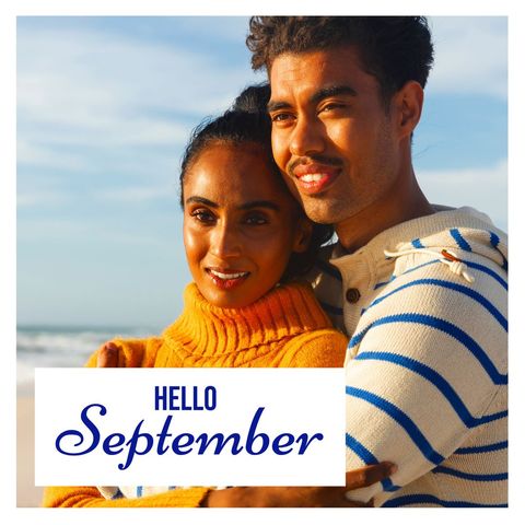 Happy couple embracing by oceanside in early fall