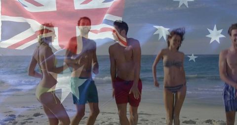 Happy friends running on australian beach, celebrating summer fun