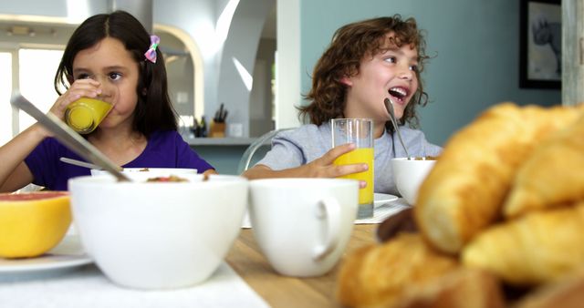 Children Enjoying Breakfast with Orange Juice and Croissants - Download Free Stock Images Pikwizard.com