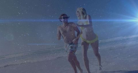 Sunlit couple running on beach at golden hour with lens flare dreamy grainy glow, vibrant sun