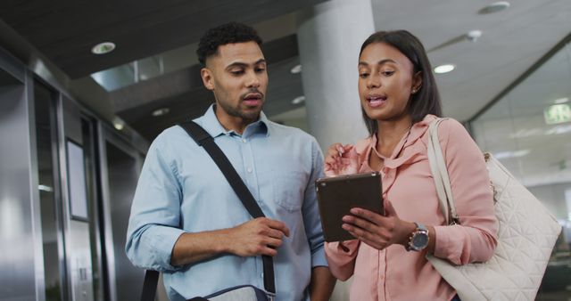 Young Multiracial Colleagues Discussing Work on Tablet in Modern Office - Download Free Stock Images Pikwizard.com