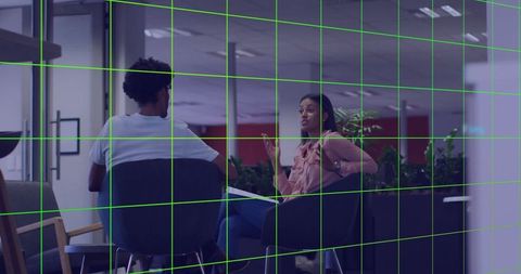 Professional discussing ideas in modern office lounge