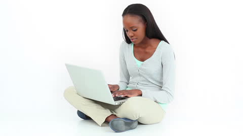 Focused Woman Using Laptop While Sitting Cross-Legged