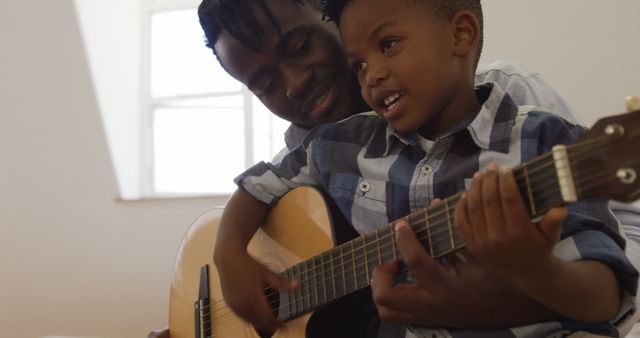 Father and Son Bonding Time Playing Guitar Together at Home - Download Free Stock Images Pikwizard.com