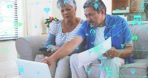 Senior Couple Engaged in Technology at Home with Digital Icons