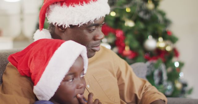 Father and Son Wearing Santa Hats Enjoying Christmas Together - Download Free Stock Images Pikwizard.com