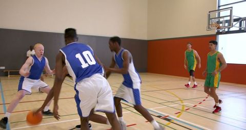 Intense Basketball Game in Indoor Gym Setting