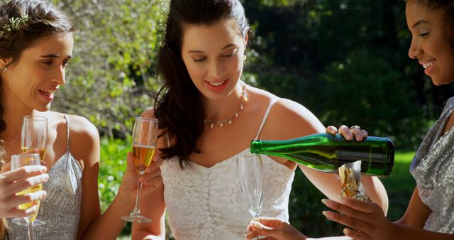 Bride Pouring Champagne for Bridesmaids at Outdoor Wedding - Download Free Stock Images Pikwizard.com