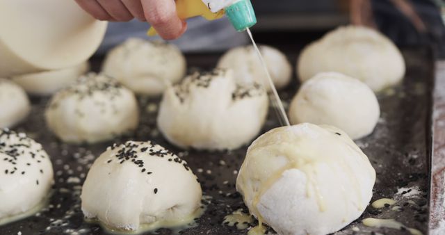 Close-Up of Hand Preparing Dough Balls with Sesame Seeds - Download Free Stock Images Pikwizard.com