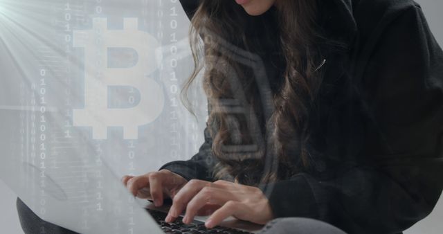 This image depicts a woman wearing a hoodie, typing on a laptop computer with the Bitcoin symbol in the background. The image suggests themes of technology, cryptocurrency, and financial innovation. The overlay of binary code and Bitcoin she emphasizes blockchain technology and cybersecurity. Suitable for articles, presentations, and marketing materials related to cryptocurrency, blockchain technology, cybersecurity, and financial services.