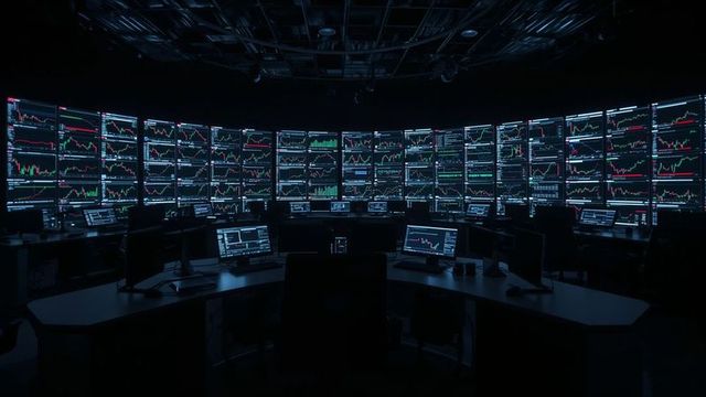 High-tech financial command room with curved monitors