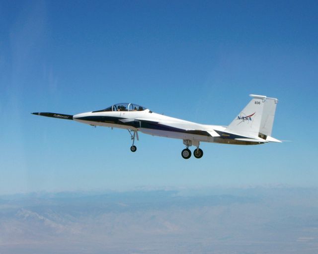 This image depicts NASA's F-15B testbed aircraft in flight over a desert environment. It's part of the NASA/Gulfstream Quiet Spike project aimed at reducing sonic booms. Use this for aviation technology articles, aerospace engineering publications, and educational materials on aerospace advancements.