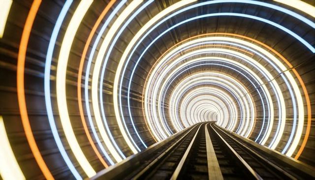 Converging rails leading through neon ring tunnel with futuristic light rings