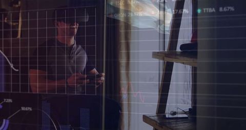 Man Exploring Virtual Finance with VR Headset in Modern Home Office