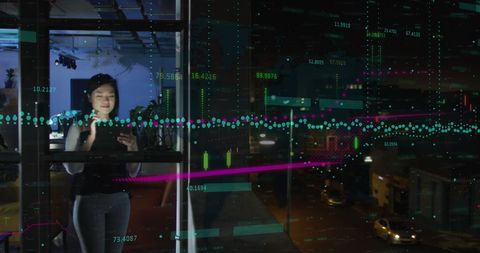 Asian Businesswoman Analyzing Data with Interactive Projections in Modern Office