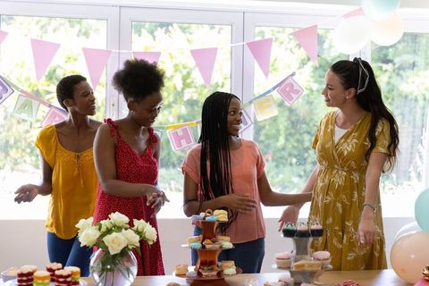 Diverse female friends celebrating with cupcakes and decor