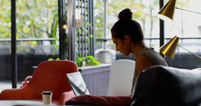 Young Woman Working on Laptop in Cozy Cafe Setting - Download Free Stock Images Pikwizard.com