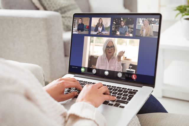 Caucasian colleagues with caucasian businesswoman during video call on laptop at home. unaltered, work from home, business, wireless technology, working, teamwork and office concept.