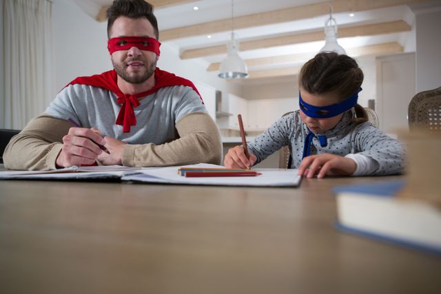 Father and son pretending to be superhero while studying
