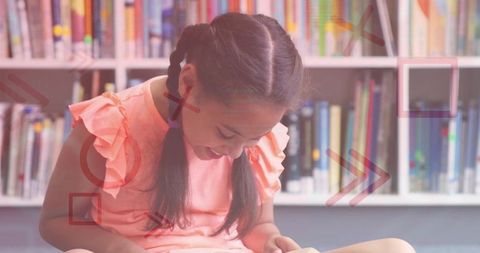 Smiling girl reading in cozy library nook with braided hair and colorful bookshelf