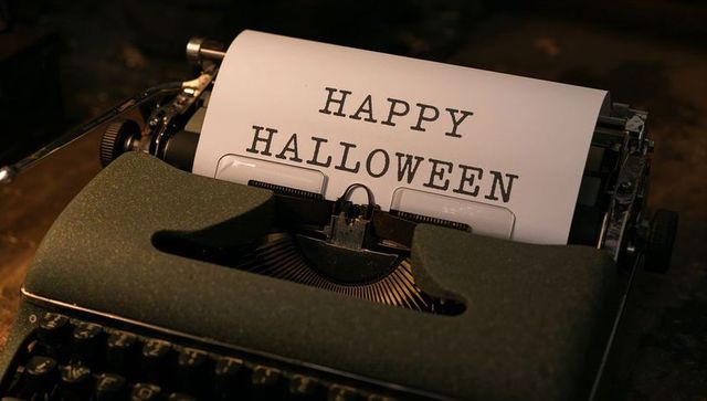 Vintage typewriter typing happy halloween in nostalgic setting