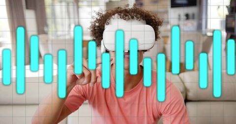 Young man wearing vr headset interacting with virtual audio waveform overlay at home