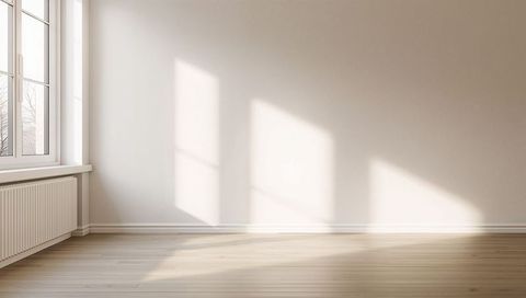 Sunlit minimalist room featuring large multi-pane window, radiator and hardwood floor