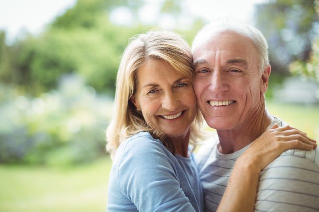 Portrait of smiling senior couple embracing outdoors