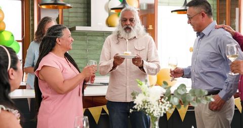 Senior Celebrating Birthday with Diverse Friends at Home