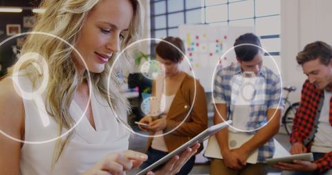 Young Professionals Embracing Technology in Modern Office