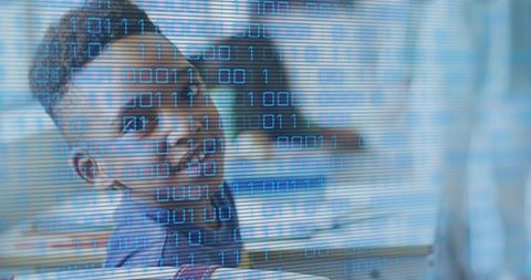 Young student turning at desk with blue binary overlay conveying digital learning focus