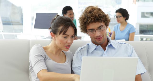 Young Professionals Collaborating on Laptop in Modern Office Setting - Download Free Stock Images Pikwizard.com