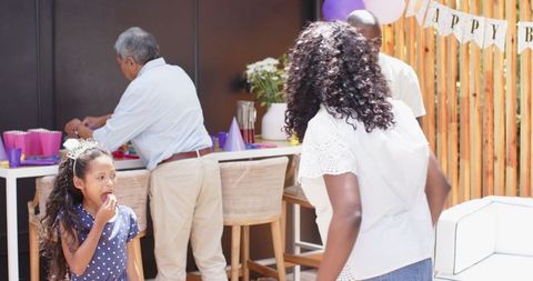 Diverse Family Setting Up Birthday Decorations at Home Celebration