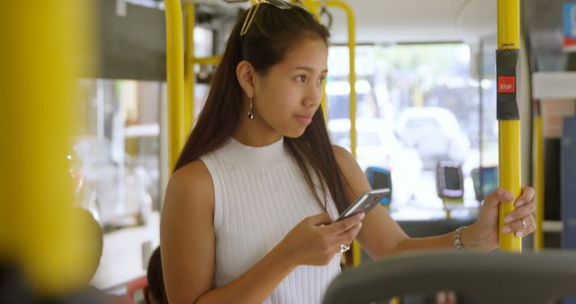 Young Woman Holding Smartphone While Riding Public Bus - Download Free Stock Images Pikwizard.com