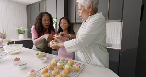 Multigenerational Family Decorating Cupcakes in Modern Kitchen — Baking and Bonding