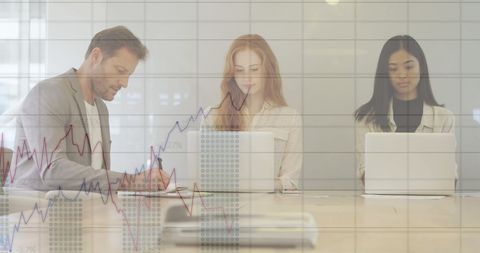 Business Team Analyzing Financial Data Using Laptops in Office