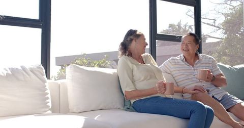 Senior Couple Enjoying Relaxing Conversation on Sunny Day at Home