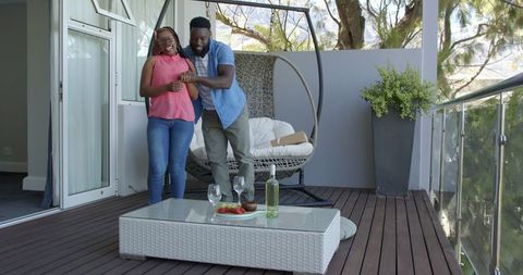 Couple Enjoying Relaxing Evening on Cozy Patio