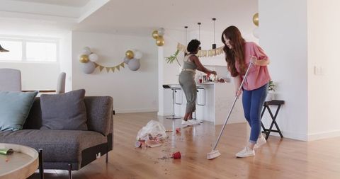 Couple Cleaning Up After Birthday Party Celebration