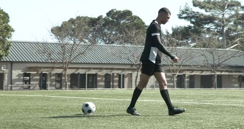 Focused Soccer Player Preparing for Practice on Sunny Day
