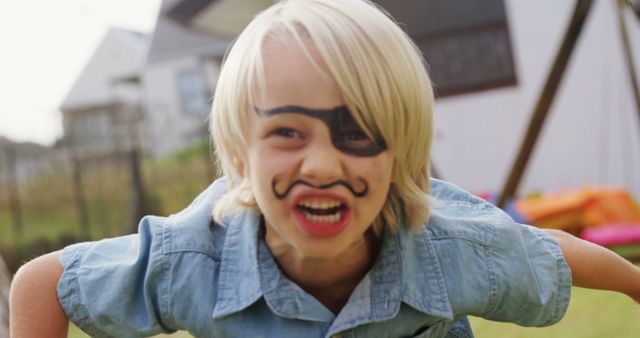 Blonde Boy with Face Paint Playing Pirate in Garden - Download Free Stock Images Pikwizard.com