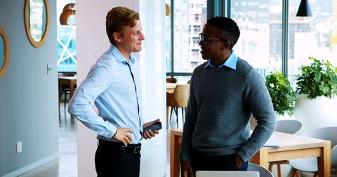 Multiracial colleagues in discussion in modern office space