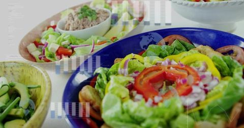 Displaying bright fresh garden salad with bell peppers and croutons in blue bowl
