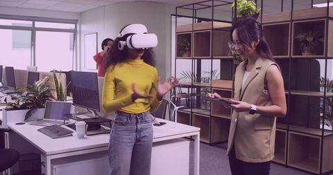 Coworkers Experiencing Virtual Reality in Modern Office