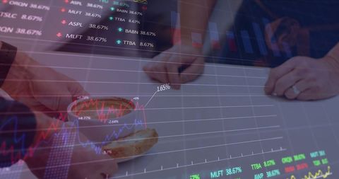 People analyzing financial data with graph overlays
