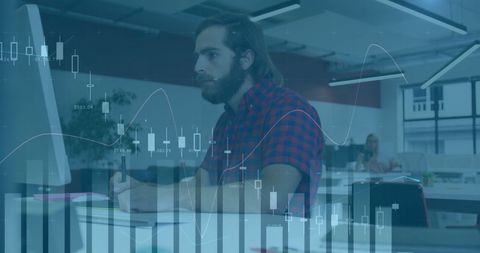 Bearded Businessman Analyzing Financial Charts in Modern Office